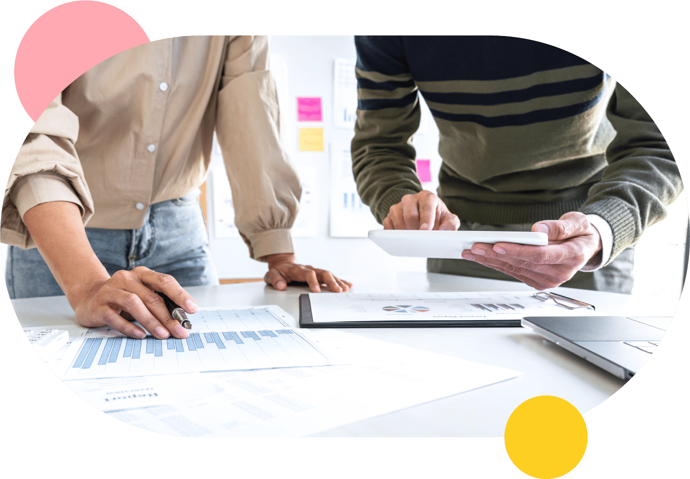 Two colleagues collaborating at a desk in a facility management setting.