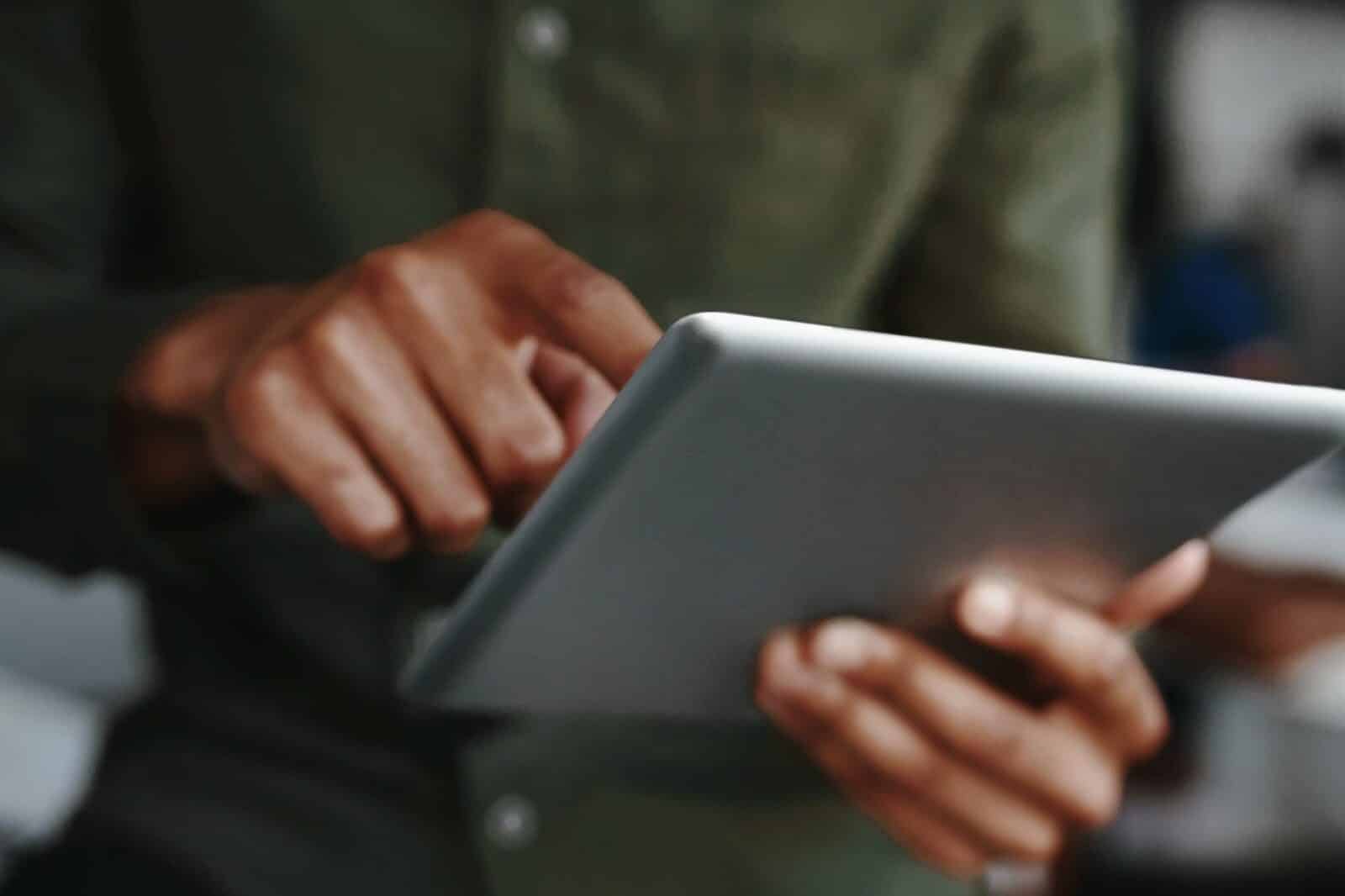 A man is using a tablet to get more done efficiently.