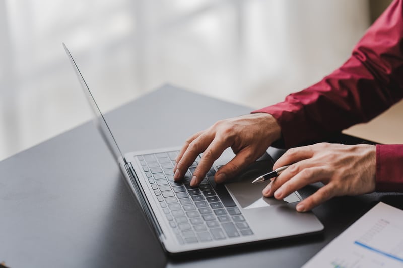 A man utilizing the Fleet Manager Module while typing on a laptop to perform a data dive.