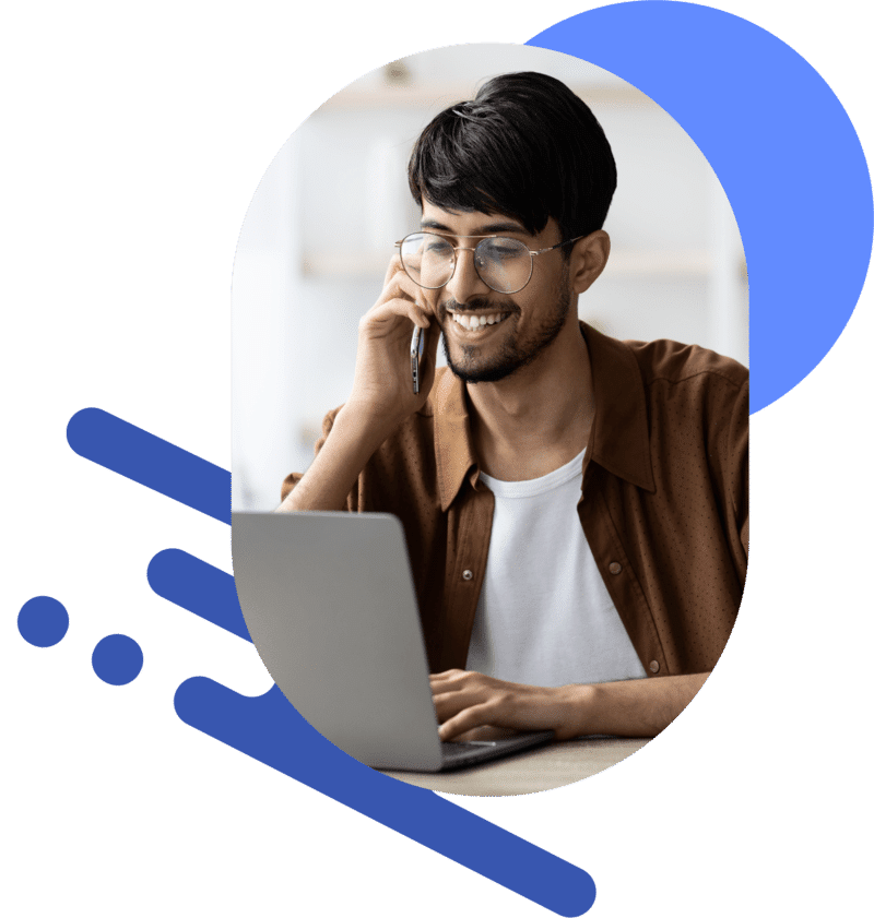 A man lectures on his laptop while talking on the phone.