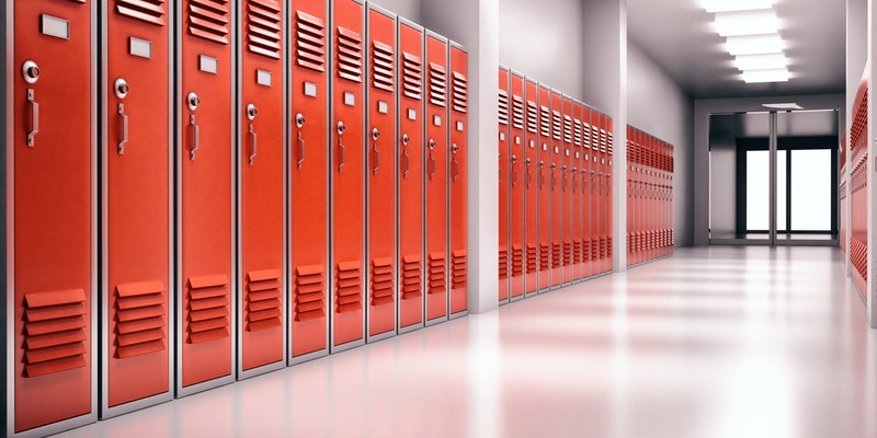 High school lobby with red color lockers, perspective view. Students storage cabinets, closed metal doors, gray color room interior background.