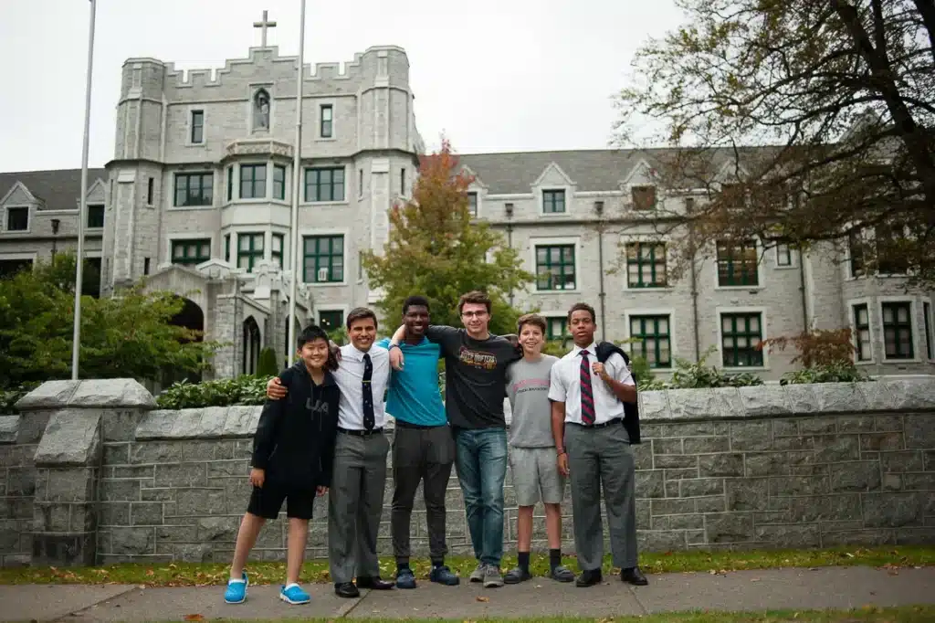 A group of students posing in front of a large building. "Right-Sized" Systems Assists Independent School with Complex Facilities Management Challenges.