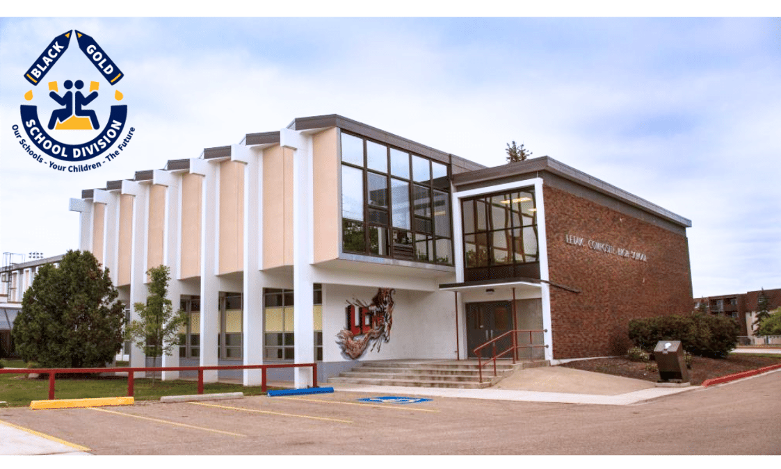 The front of a school building with a Black Gold School Division sign on it.