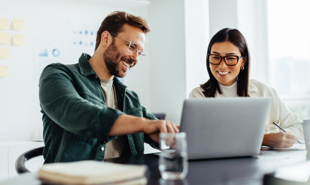 Get to Know ebase Resource Manager 10 Two people on laptop e1715091096577