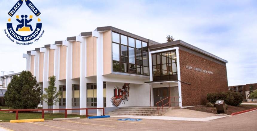 The front of a school building with a Black Gold School Division sign on it.