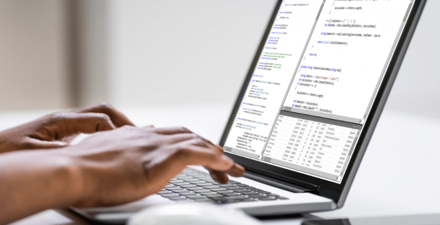 A person typing on a laptop computer while considering the benefits of upgrading their facility's CMMS to ebase.