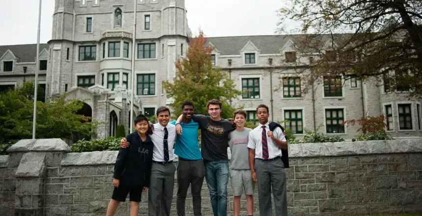 A group of students posing in front of a large building. "Right-Sized" Systems Assists Independent School with Complex Facilities Management Challenges.